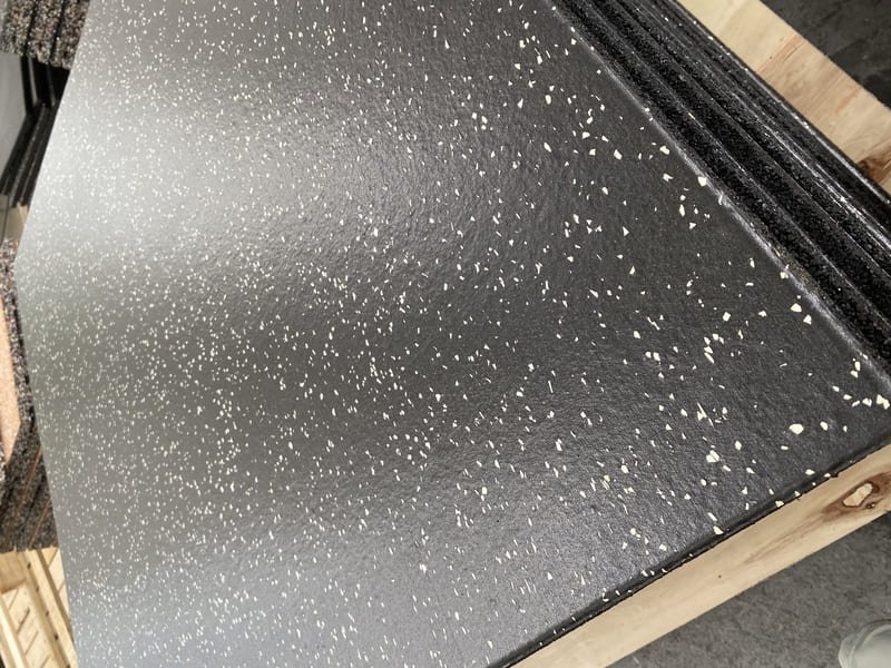 A high-performance gym with specialized rubber flooring in the weightlifting area.